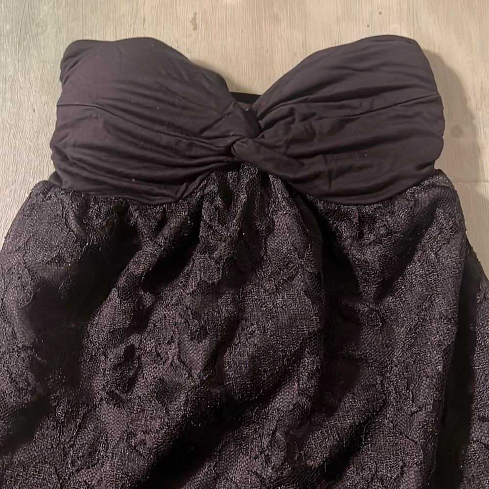Black sweetheart mini dress with lace body and adjustable tie in back.